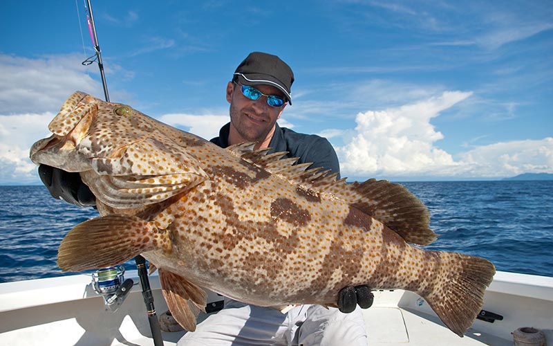 Couple relaxing on the beach after a day of fishing in Florida